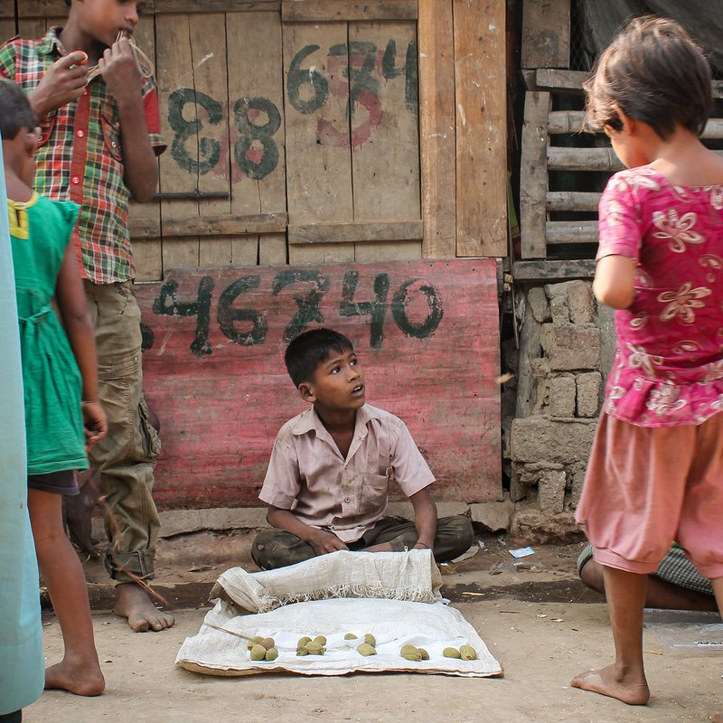 Children displaying goods for sale on a blanket